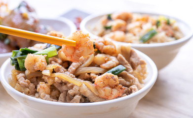 Braised shrimp over rice - Taiwan famous traditional street food. Soy-stewed prawn and sliced pork on cooked rice. Travel concept, copy space, close up
