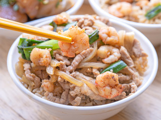 Braised shrimp over rice - Taiwan famous traditional street food. Soy-stewed prawn and sliced pork on cooked rice. Travel concept, copy space, close up