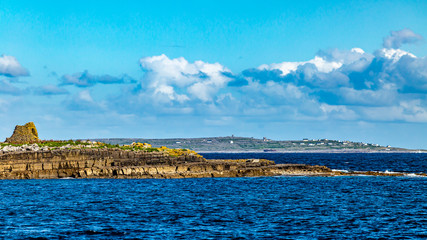 Small Crab island are within walking distance of Doolin harbor with the ruins of a 19th century police post, Wild Atlantic Way, beautiful sunny spring day in County Clare in Ireland