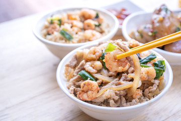 Braised shrimp over rice - Taiwan famous traditional street food. Soy-stewed prawn and sliced pork on cooked rice. Travel concept, copy space, close up
