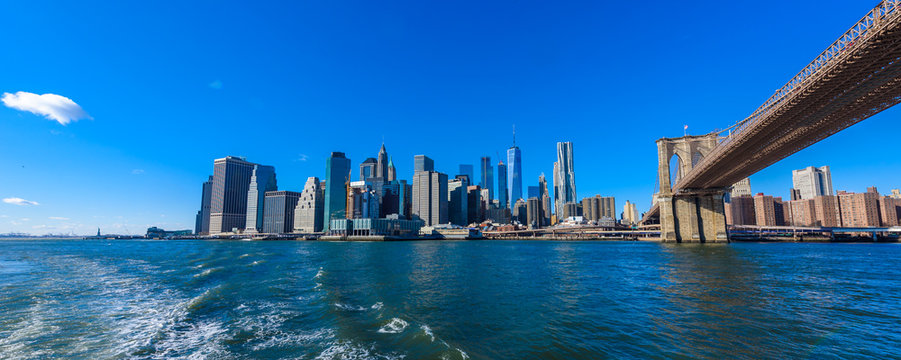 Famous Skyline of downtown New York City, Brooklin Bridge and Manhattan with skyscrapers illuminated over East River panorama. New York, USA