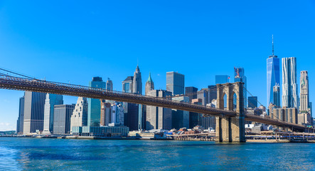 Fototapeta na wymiar Famous Skyline of downtown New York City, Brooklin Bridge and Manhattan with skyscrapers illuminated over East River panorama. New York, USA