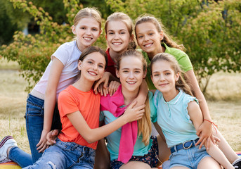 Friends sitting on the grass eating healthy food at a lunch