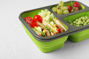 School lunch box with tasty food on white background