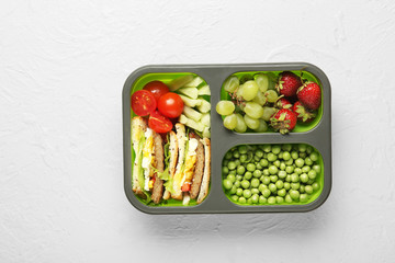 School lunch box with tasty food on white background