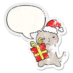 cute cartoon cat carrying christmas present and speech bubble distressed sticker