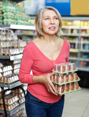 woman shopping for eggs in food department