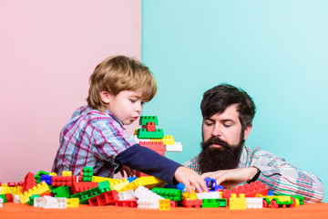 Happy family together. small boy with dad playing together. father and son play game. happy family leisure. child development. building home with color constructor kit. block kit. kit toy. toy shop