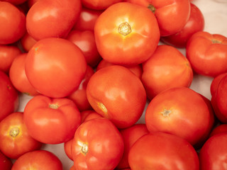 Background - red tomatoes of medium size. blurred.