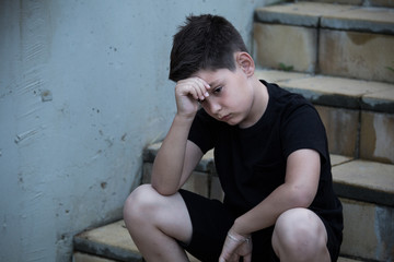 Portrait of a sad teenage boy looking thoughtful about troubles. Pensive teen. Depression, teen depression, pain, suffering.