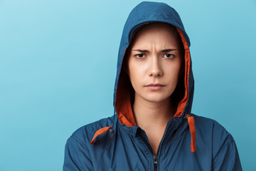 Close up portrait of an upset young girl wearing hood