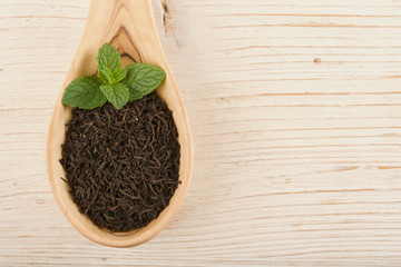 black tea on wooden background