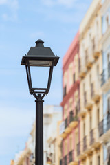 Fototapeta na wymiar Antique street lamp on the background of old buildings. Tarragona, Spain.