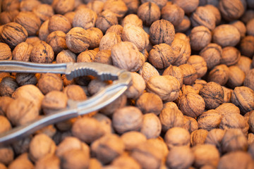 Stack of shelled walnuts and nutcracker for baclground picture