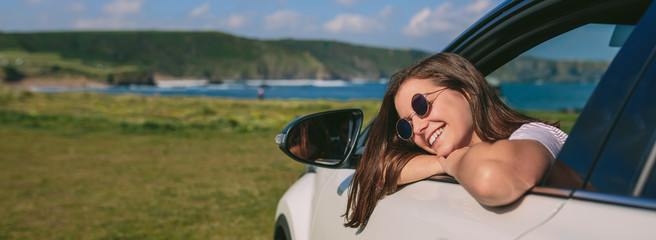 Relaxed girl leaning looking out the window of the car