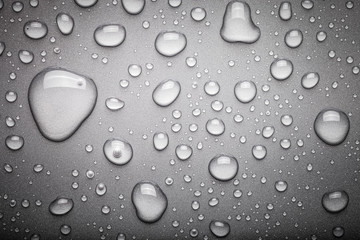 Drops of water on a color background. Dark grey. Toned