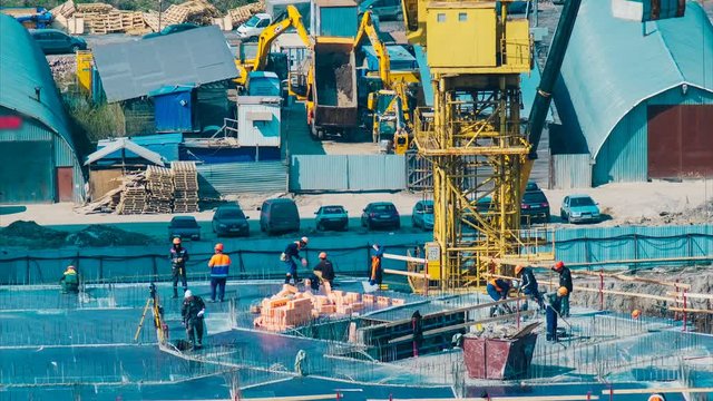 yellow cranes and professionals in uniforms with logo work