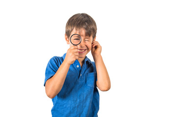 Child boy with books and loupe on white background.