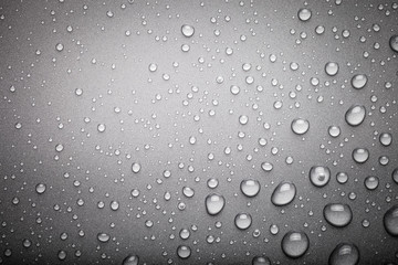 Drops of water on a color background. Dark grey. Toned