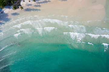 Aerial top view of ocean waves, beach and rocky coastline and beautiful forest. Beautiful nature...