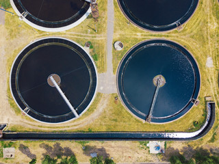 Modern wastewater treatment plant, top view from drone, sedimentation drainage tanks round form