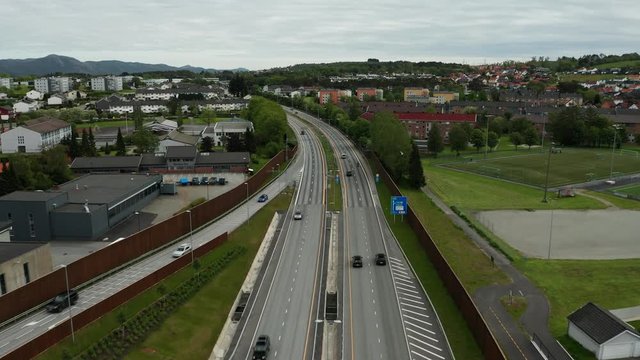 Cinematic Aerial of E39 Highway With Cars and Residental Houses in Suburbia of Stavanger Oil Capital Of Norway