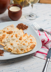 Caucasian qutab, kutab, gozleme served with sumakh, herbs and yogurt.