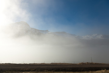 Naklejka na ściany i meble Foggy landscape of the fjords of Iceland