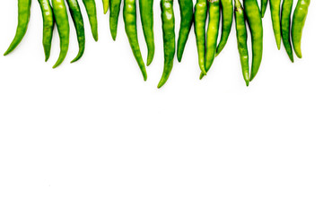 Fresh green chilli pepper as food ingredient on white table background top view mockup