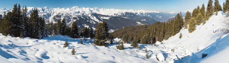 Panoramic view across snow covered alpine mountain range