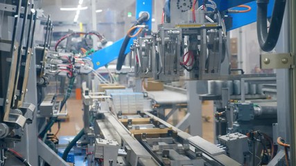 Factory complex is making and packaging carton boxes. Modern robotic factory equipment.