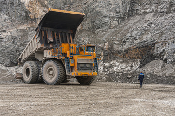 Gigat dump trucks are working in the mine for the production of apatite in the Murmansk region carrying rock.