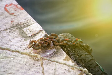 Boat chain and old tires for, mooring of ships on river