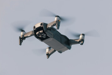 A flying drone on the background of the sky