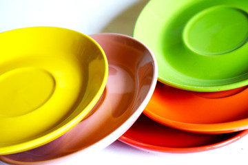 Dishes of yellow and green colors placed informally.