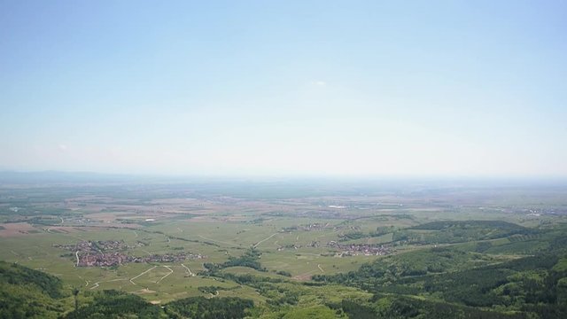 Aerial panning over Upper Rhine Valley and Alsatian Vineyard Route Route des vins dialysate - green vivid forest, vineyards and tiny villages