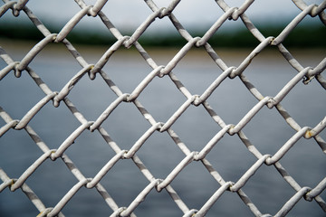 Mesh cage fence with wire behind, marine concept