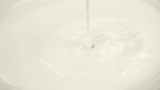 Pouring Milk closeup. Milk Splesh Slow Motion.