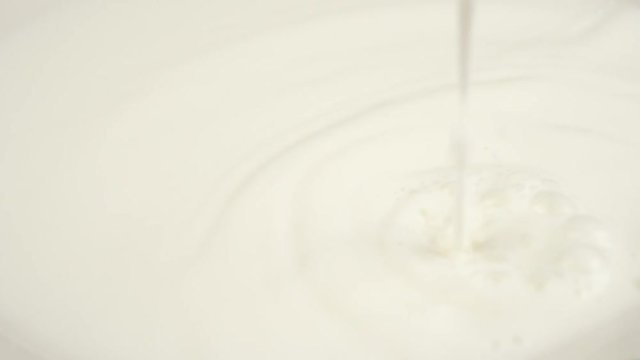 Pouring Milk closeup. Milk Splesh Slow Motion.