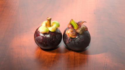 Tropical fruits mangosteen on the wooden table