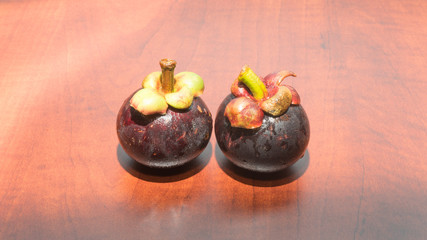 Tropical fruits mangosteen on the wooden table