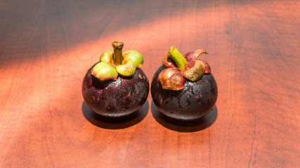 Tropical fruits mangosteen on the wooden table
