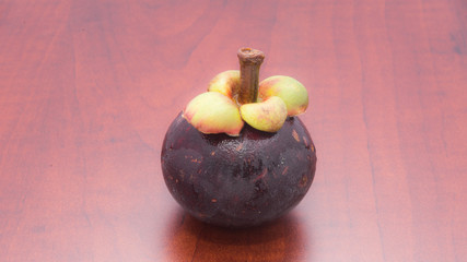 Tropical fruits mangosteen on the wooden table