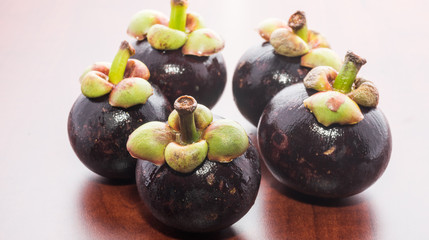 Tropical fruits mangosteen on the wooden table