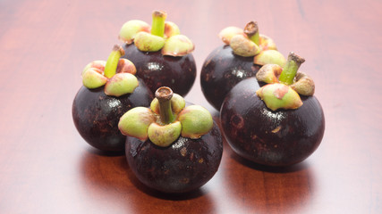 Tropical fruits mangosteen on the wooden table