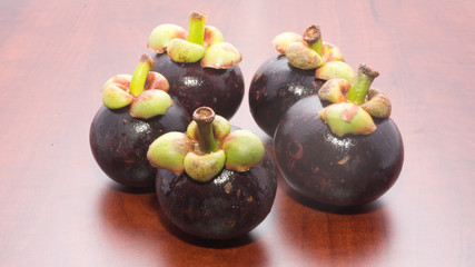 Tropical fruits mangosteen on the wooden table