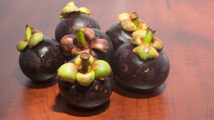 Tropical fruits mangosteen on the wooden table