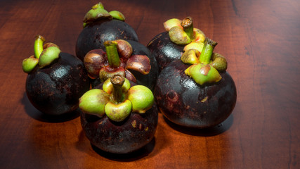Tropical fruits mangosteen on the wooden table