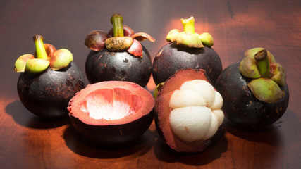 Tropical fruits mangosteen on the wooden table