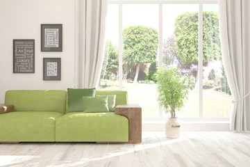 Fototapeta premium Stylish room in white color with sofa and summer landscape in window. Scandinavian interior design. 3D illustration